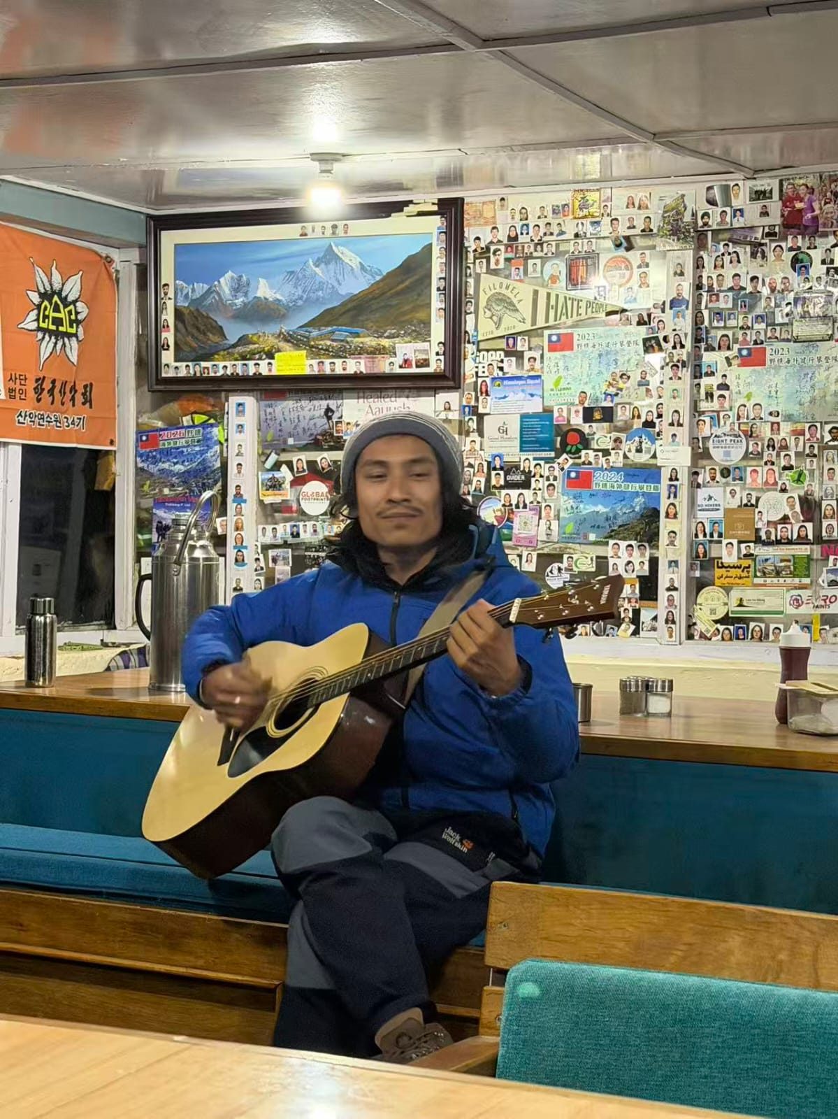 Local guide playing guitar at a teahouse